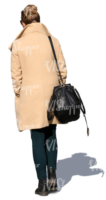 woman in a beige overcoat walking