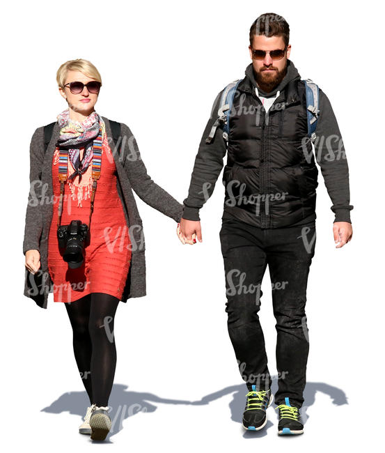 couple walking hand in hand on a sunny spring day