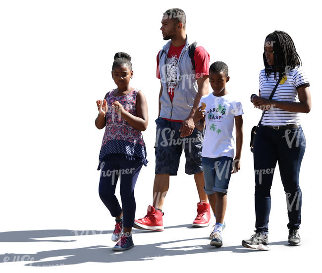 backlit african family of four walking down the street 