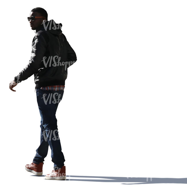 backlit black man walking on the street