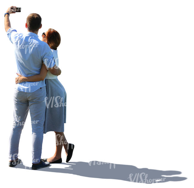 backlit couple taking a selfie