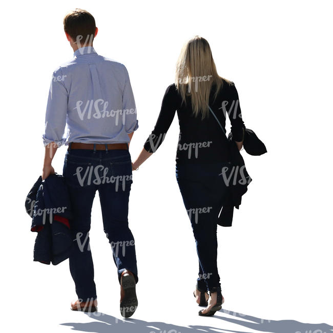 backlit couple walking hand in hand