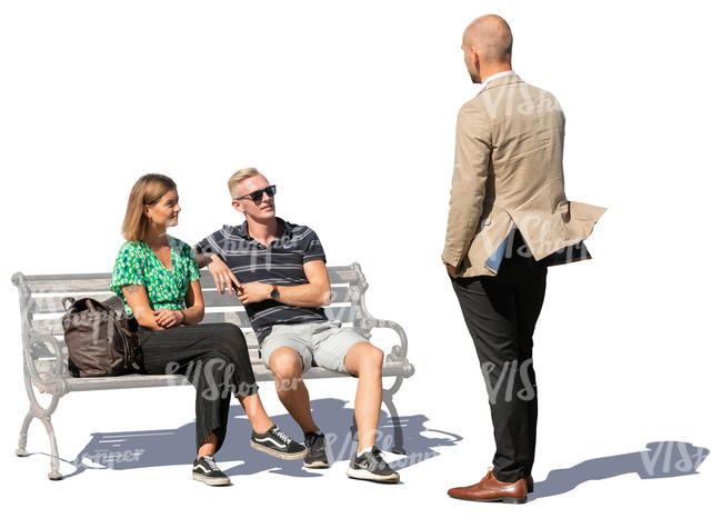 two people sitting talking with a standing man