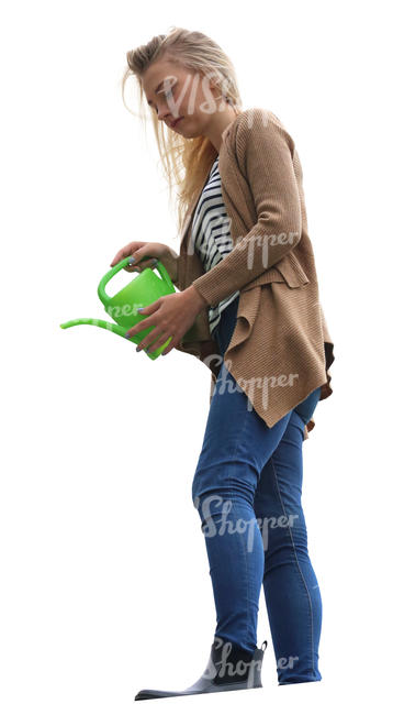 woman standing on a balcony and watering plants