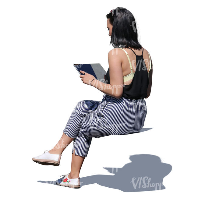 asian woman sitting and looking at tablet