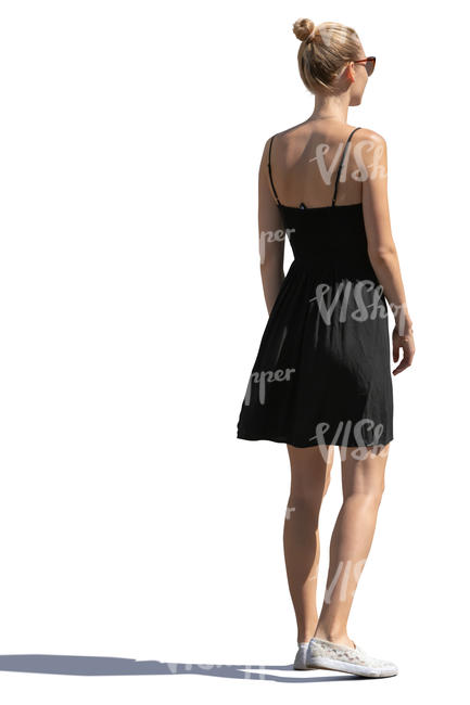 sidelit woman in a black summer dress standing