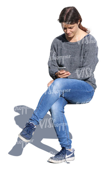 woman sitting and looking at her phone