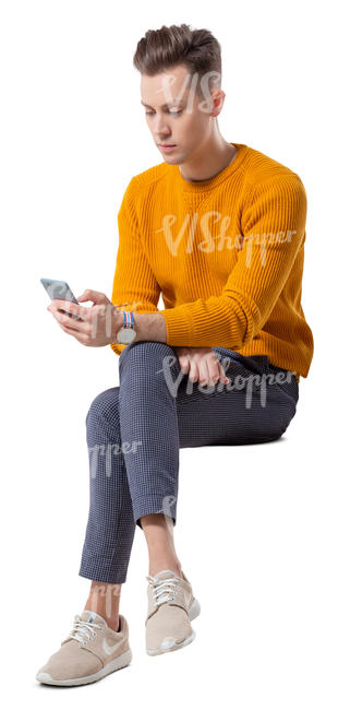 young man sitting and looking at his phone