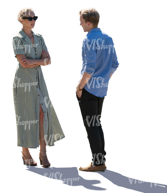 backlit man and woman standing and talking