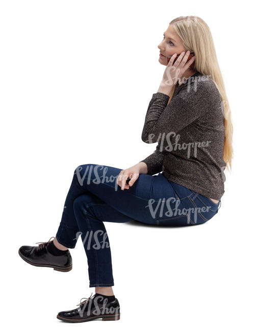 woman sitting and talking on a phone