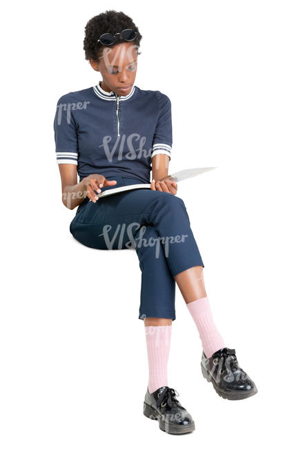 black woman sitting and reading a magazine