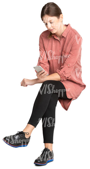 woman sitting and looking at her phone