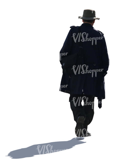 backlit man with a coat and hat walking