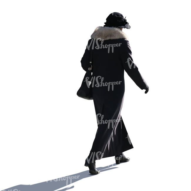 backlit woman in a winter coat walking