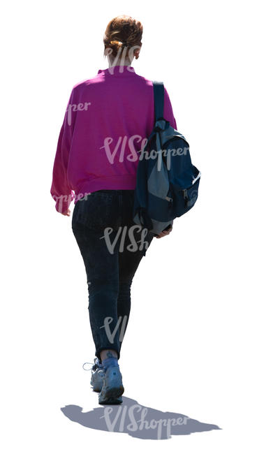 backlit woman with a backpack walking