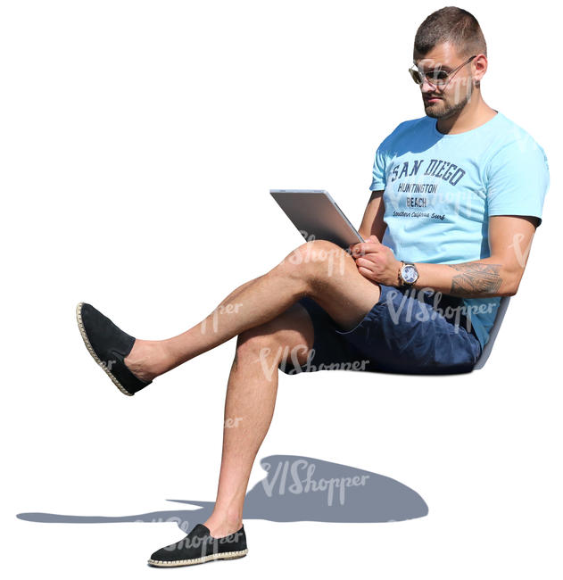 man sitting and reading smth on a tablet