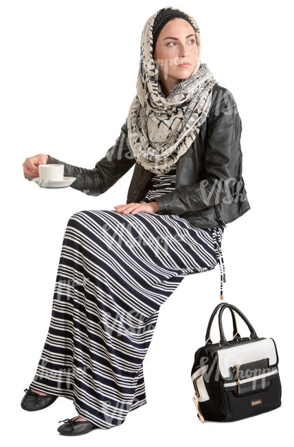 muslim woman sitting in a cafe