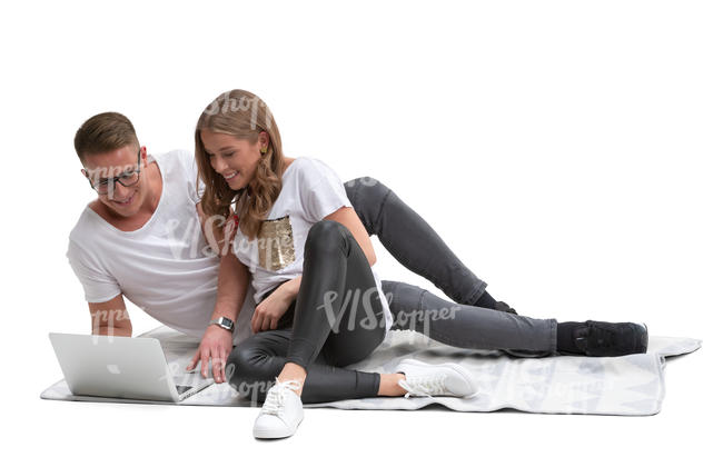 couple lying on the blanket and watching videos.