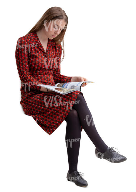 young woman sitting and reading a magazine