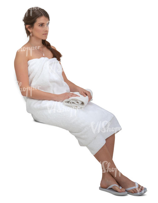 woman wrapped in spa towel sitting