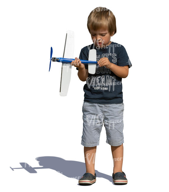 little boy playing with a toy plane