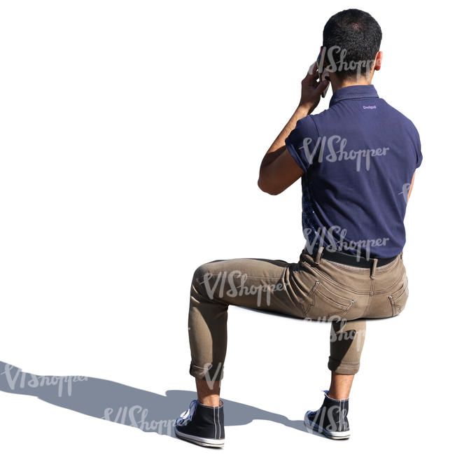 man sitting in the sun and talking on the phone