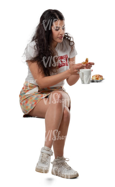 woman eating a bun in a cafe