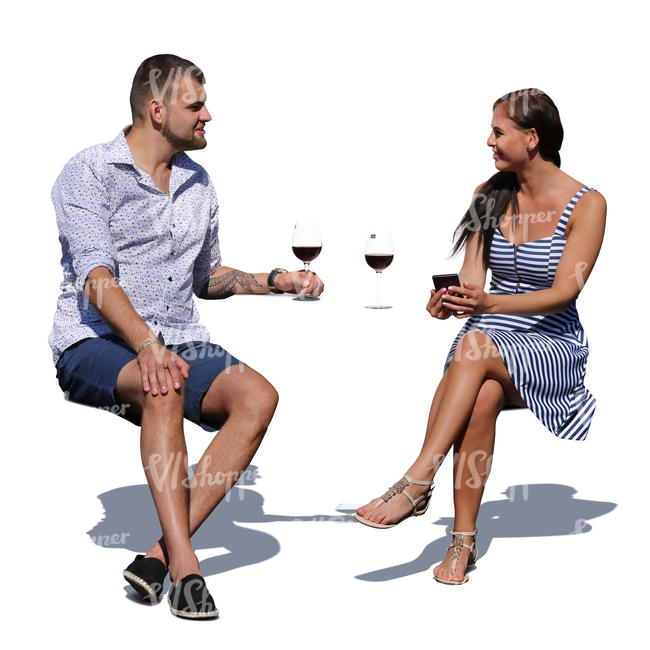 man and woman sitting in an outdoor cafe