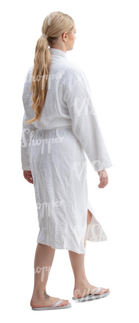woman in a white spa bathrobe walking
