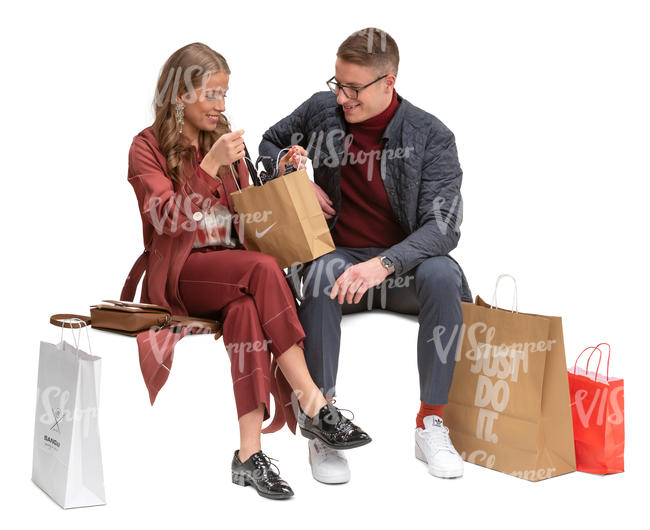 man and woman with shopping bags sitting