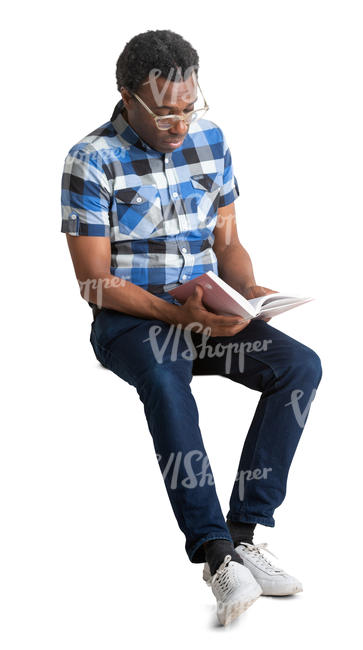 black man sitting and reading a book