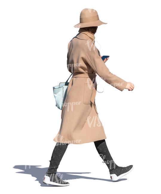 woman in a brown overcoat and hat walking