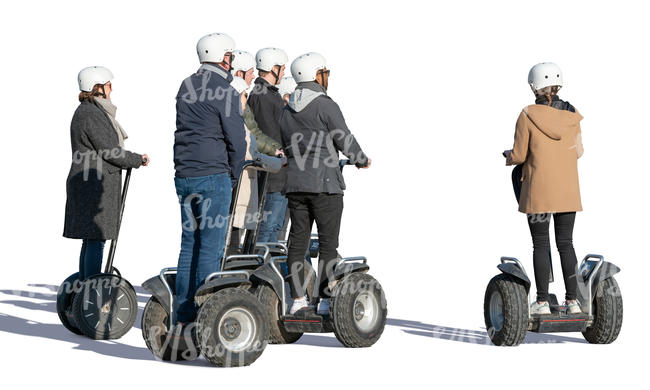 group of adults riding segways