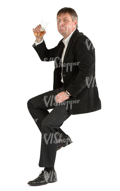 man in a suit sitting at a bar and drinking beer