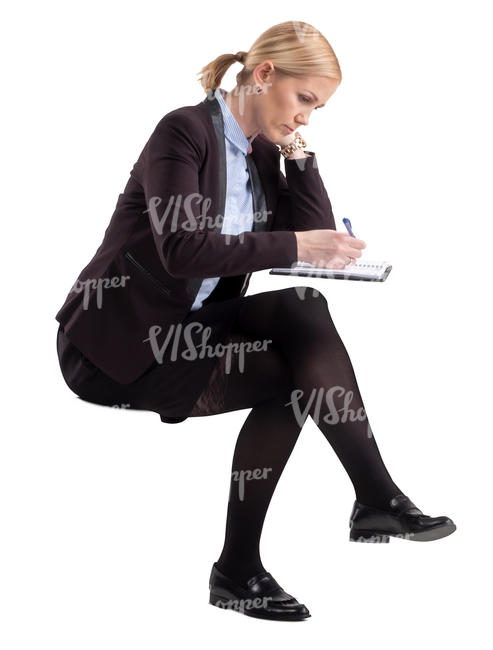 woman sitting and writing in an office
