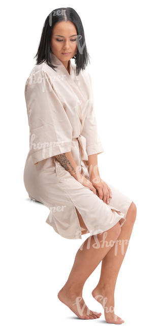 woman in a satin bathrobe sitting