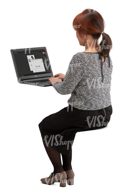 asian woman sitting behind an office desk