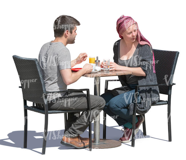 man and woman sitting in a street cafe