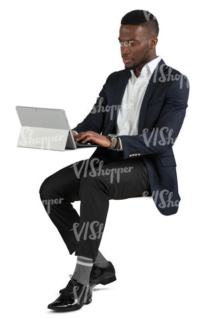 black man sitting and working with laptop