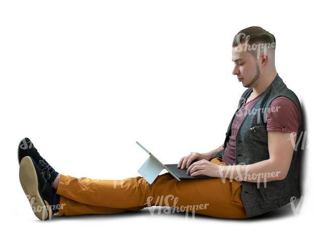 man sitting on the floor and working on a tablet