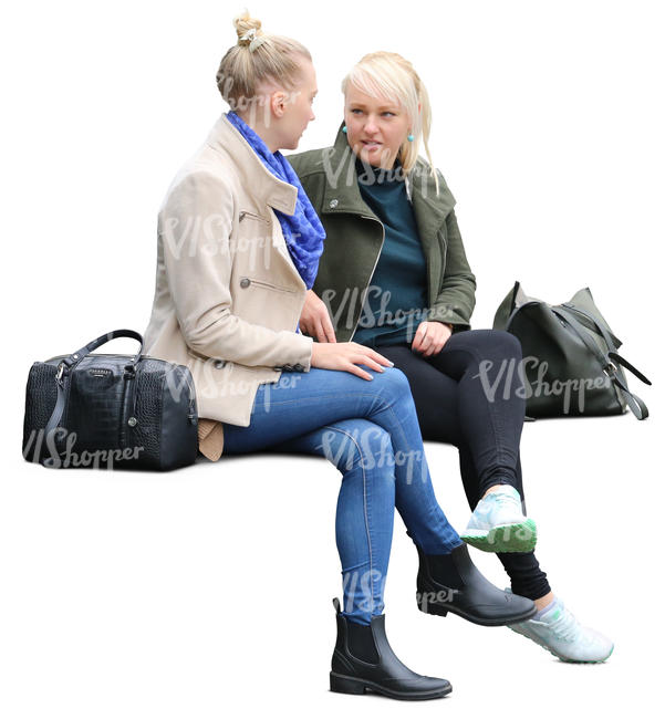 two women sitting on a bench and talking