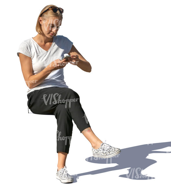 woman sitting and looking at her phone