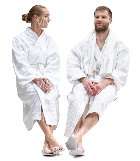 man and woman in bathrobes sitting in a spa and talking 