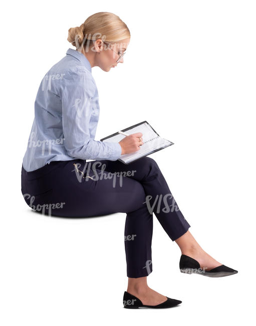 woman in an office sitting and writing