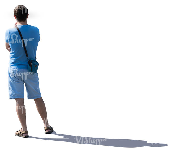 young backlit man standing