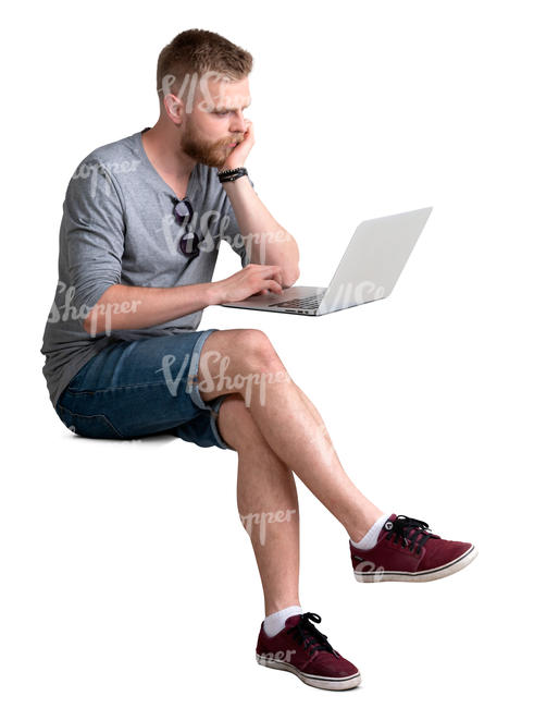 man with a laptop sitting behind the desk