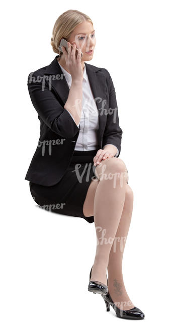 woman in an office sitting and talking on the phone