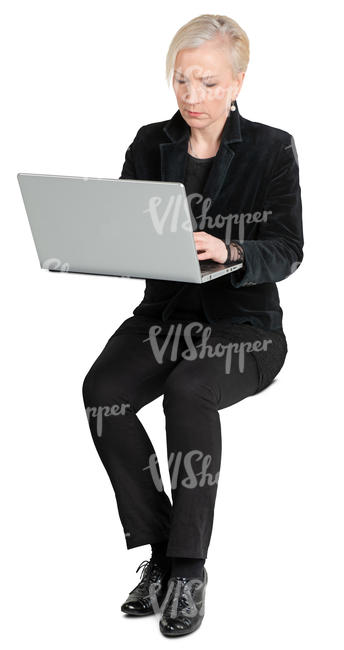 woman sitting and working on a laptop