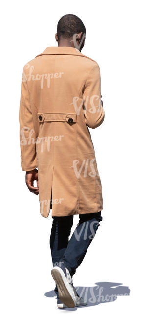 black man in a beige coat walking