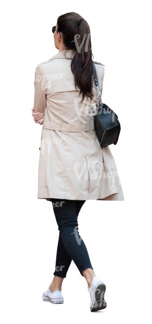 woman in a light overcoat walking